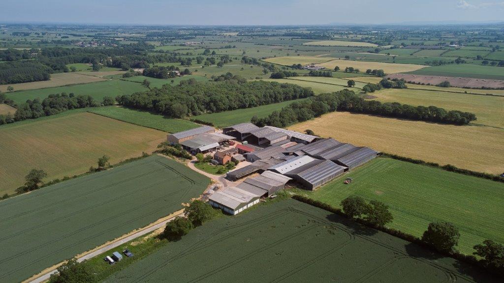 Aerial shot of Willow Tree Farm including buildings and fields